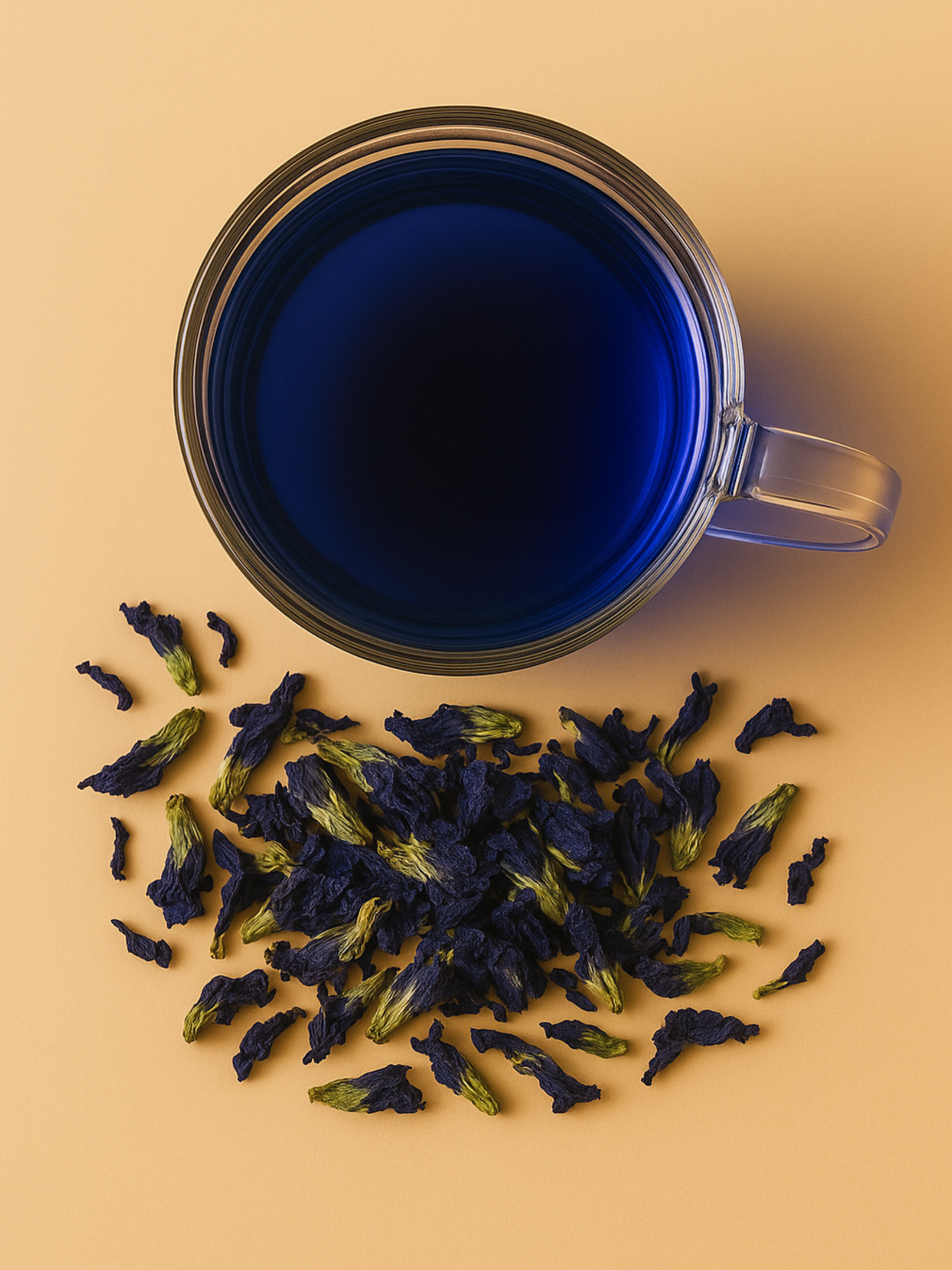 Luna Blooms Aura tea brewed in a glass mug, with dried butterfly pea flowers scattered beneath on a soft beige backdrop.